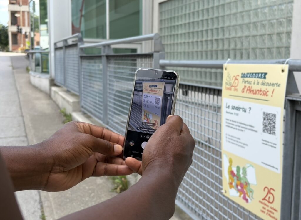 Numérisation du code QR d’une affiche du parcours interactif de Pause Famille. Photo crédit: Pamela Nassour / JDV